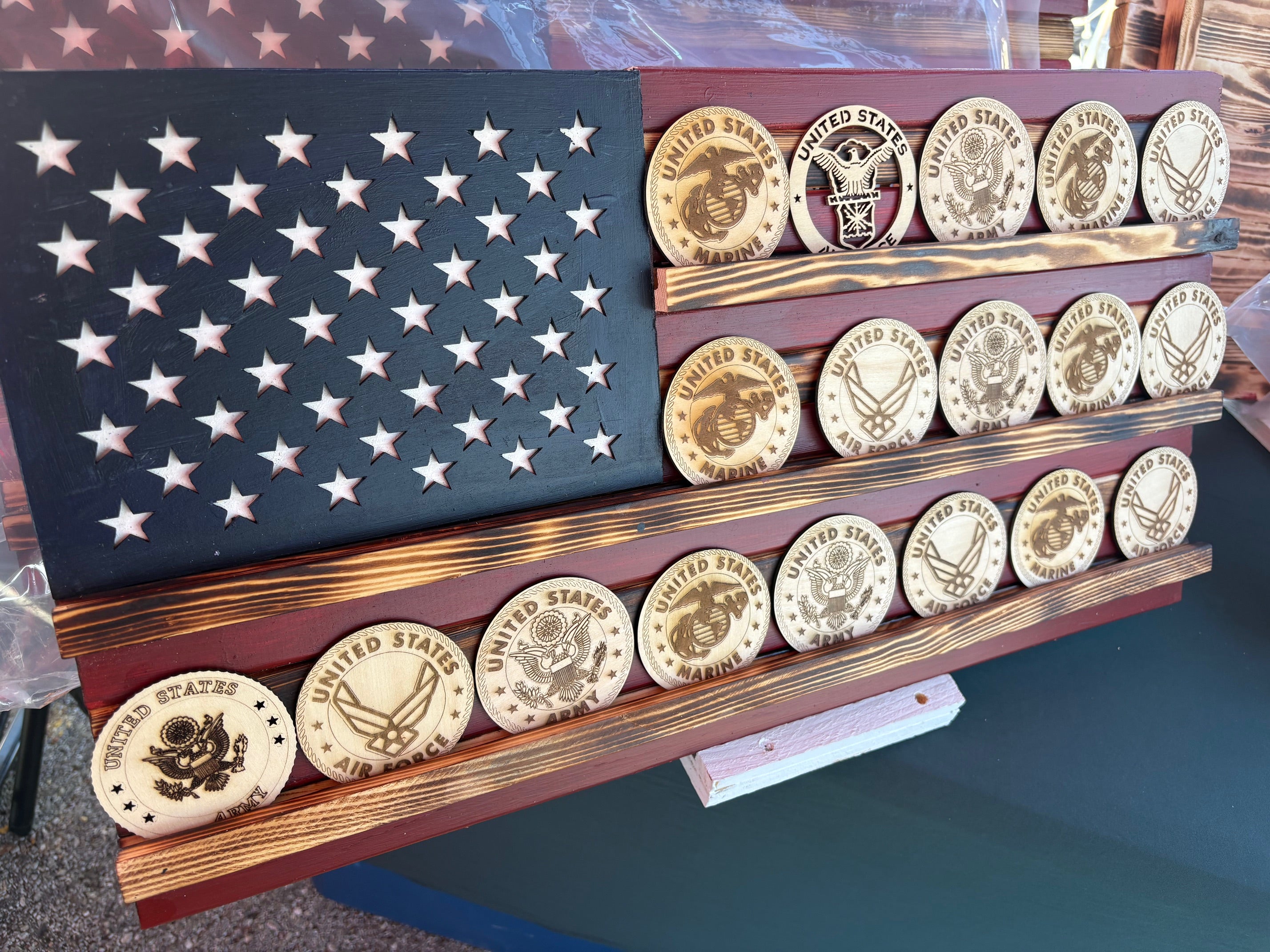 Showcase your remarkable collection of coins with pride using this stunning American flag challenge coin display. Crafted from high-quality wood, this American-made flag not only honors your experiences but also adds a touch of patriotism to any space.