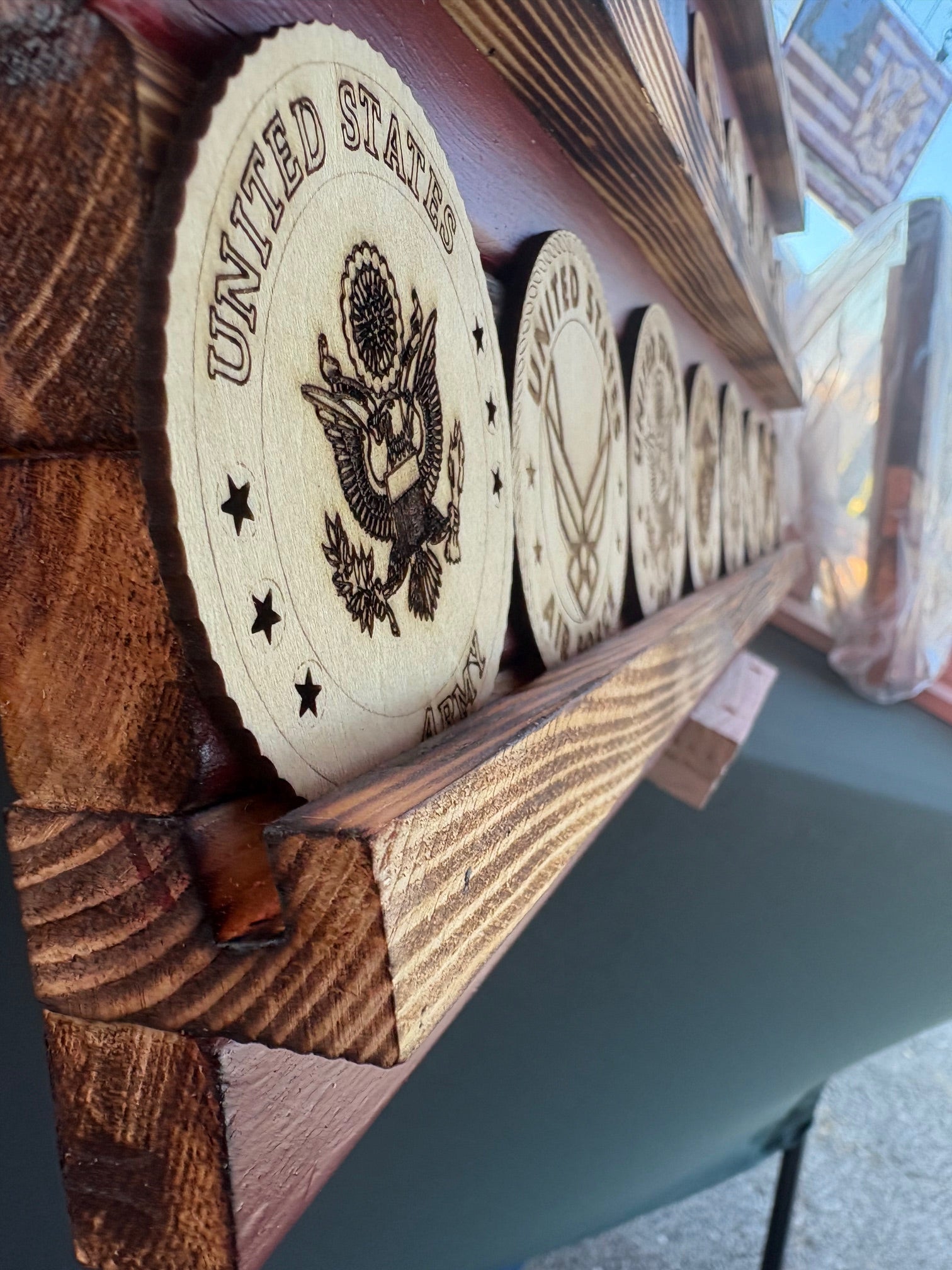 Showcase your remarkable collection of coins with pride using this stunning American flag challenge coin display. Crafted from high-quality wood, this American-made flag not only honors your experiences but also adds a touch of patriotism to any space.