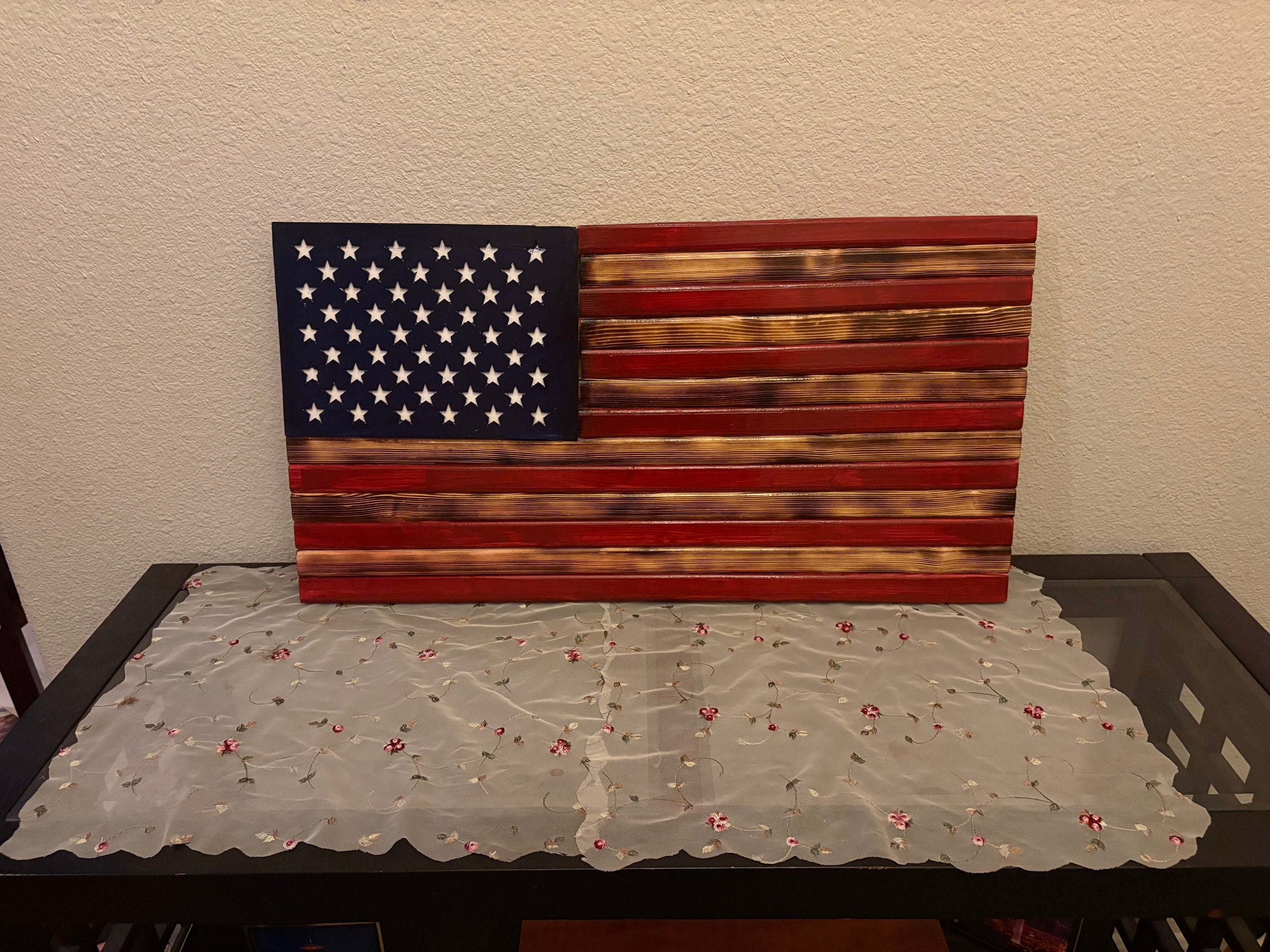 Measuring aproximate 18 by 30 inches, this Rusty American Handcrafted Flag is expertly designed to exhibit a vintage, weathered appearance that delivers authentic rustic charm.
