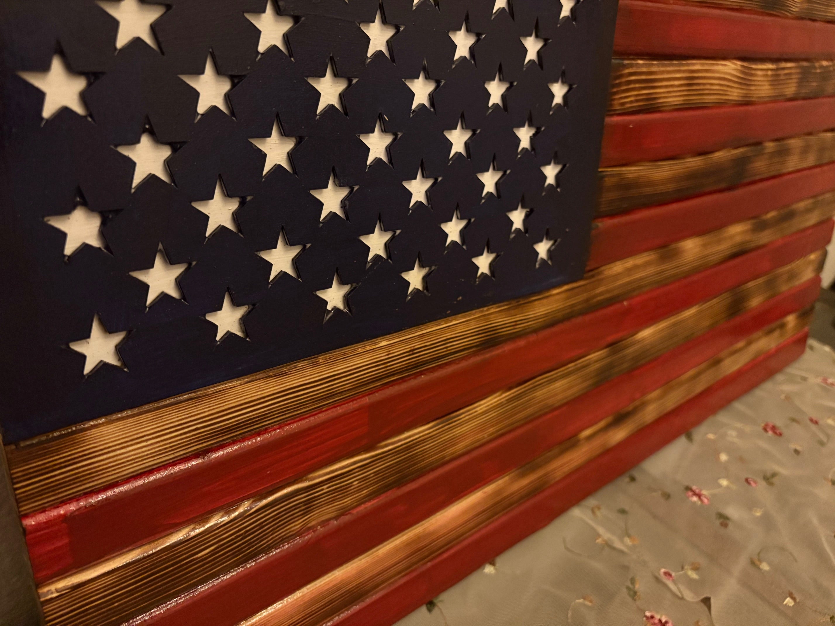 Measuring aproximate 18 by 30 inches, this Rusty American Handcrafted Flag is expertly designed to exhibit a vintage, weathered appearance that delivers authentic rustic charm.
