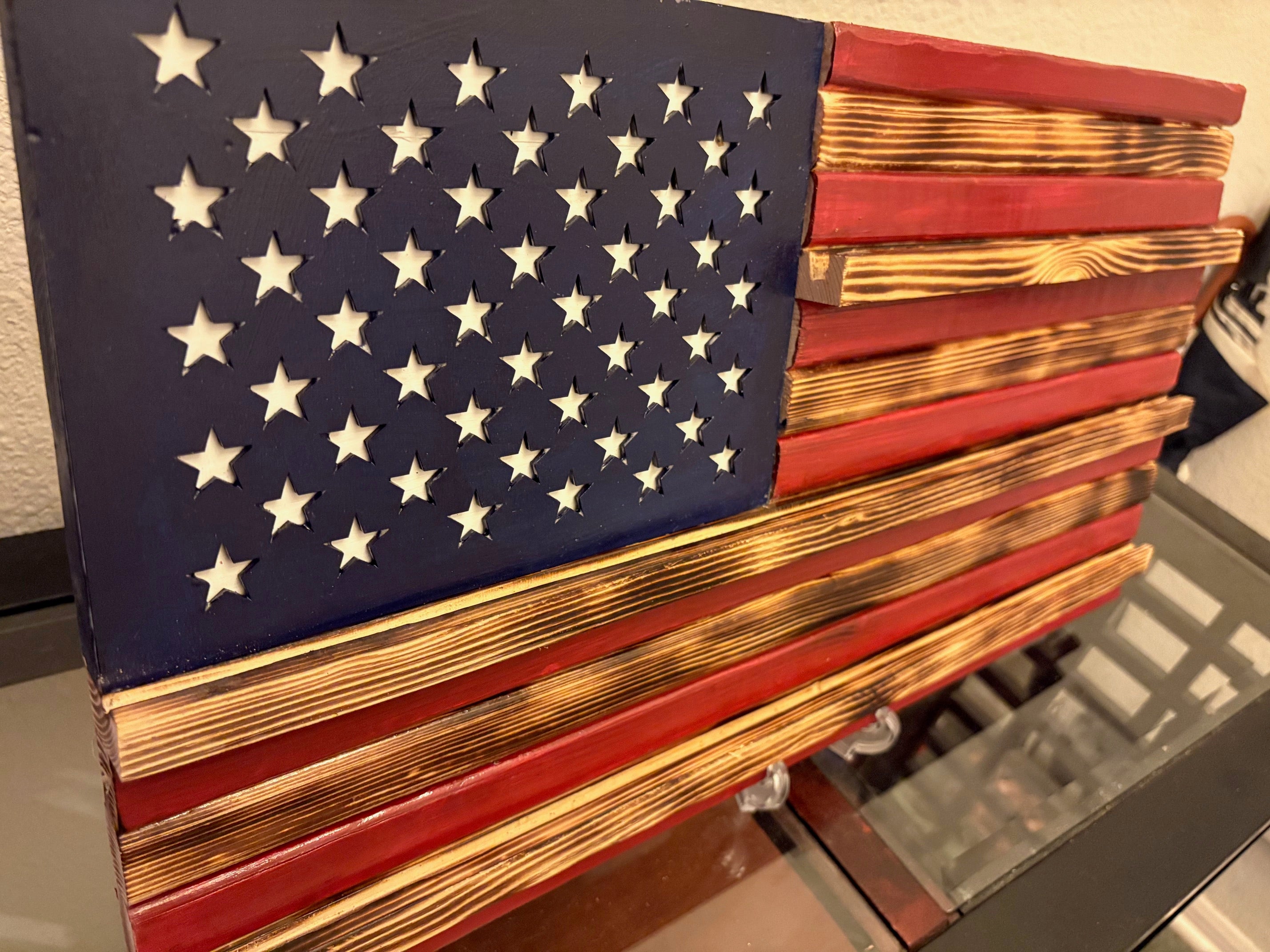 Showcase your remarkable collection of coins with pride using this stunning American flag challenge coin display. Crafted from high-quality wood, this American-made flag not only honors your experiences but also adds a touch of patriotism to any space.