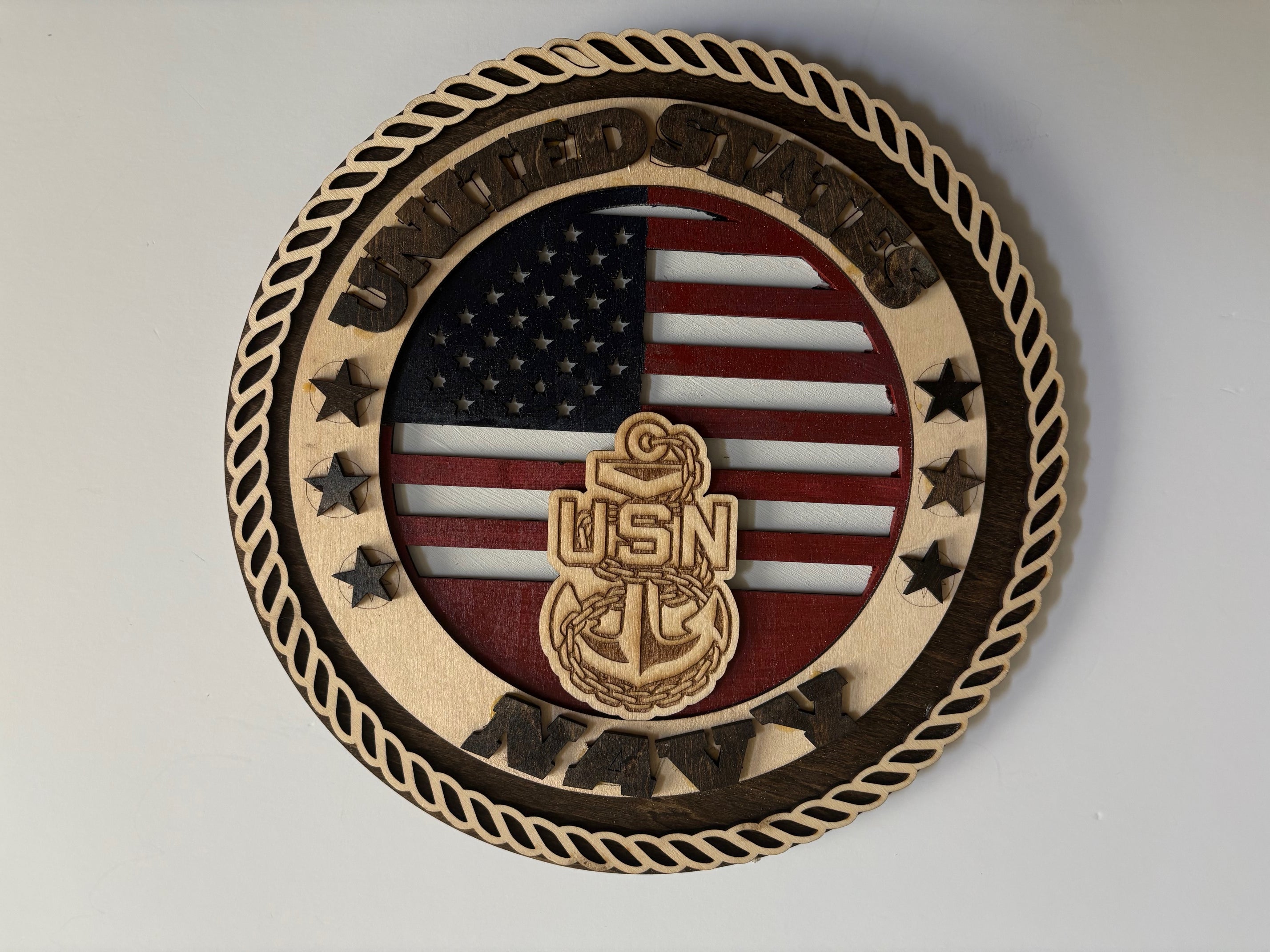 handcrafted U.S. Navy plaque showcases a finely detailed anchor over a beautifully painted American flag, embodying honor and dedication.