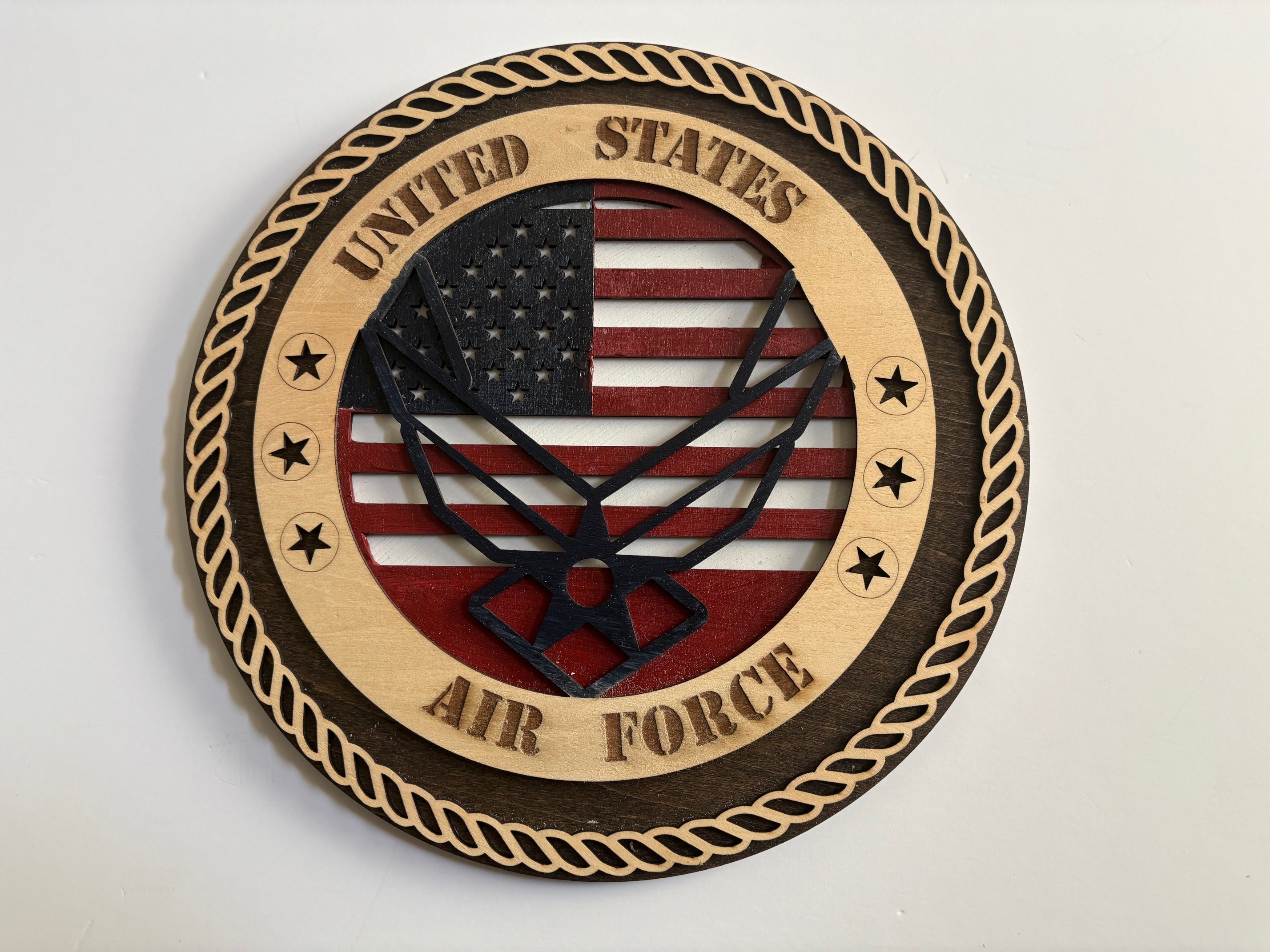 This 10-inch handcrafted U.S. Airforce plaque features a finely detailed Logo set against a meticulously painted American flag backdrop,