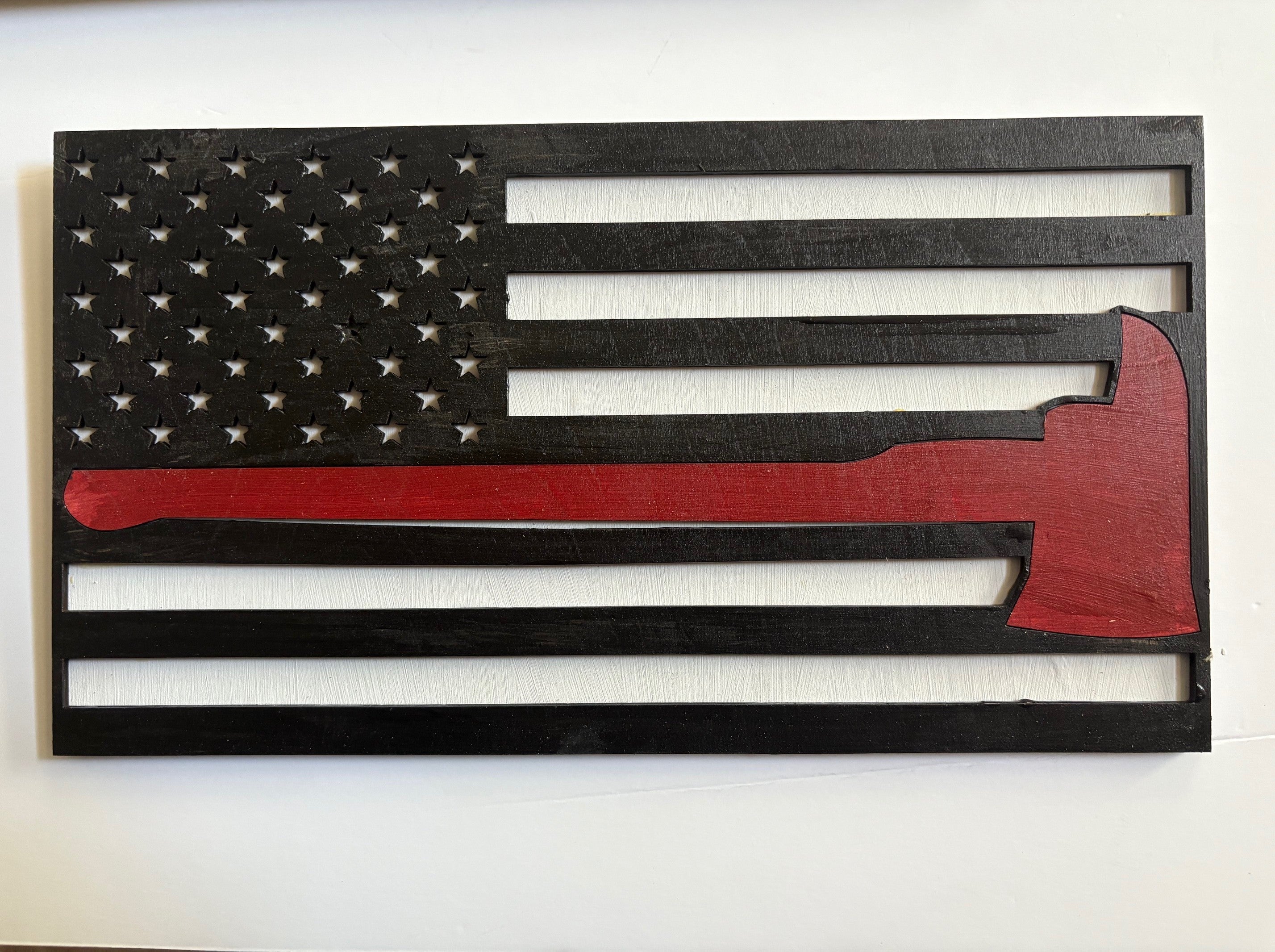 American flag integrated with a fireman's axe, symbolizing courage and dedication.
